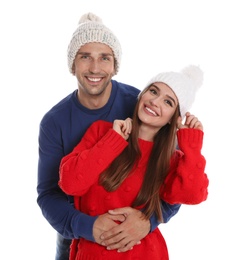 Photo of Happy young couple in warm clothes on white background. Winter season