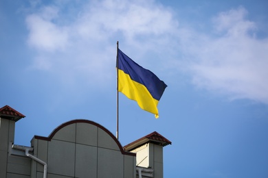 Photo of Ukrainian flag on building against blue sky