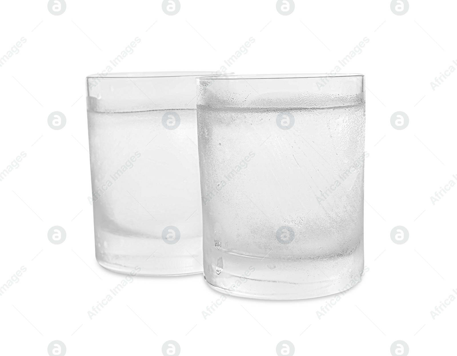 Photo of Vodka in shot glasses on white background