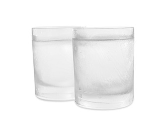 Vodka in shot glasses on white background