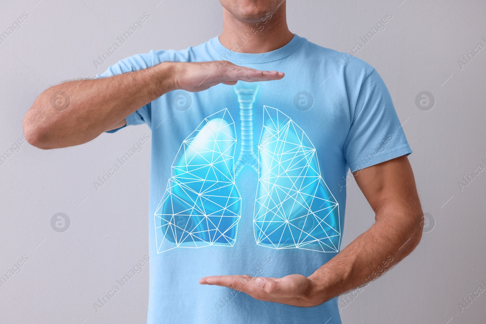 Image of Man holding hands near chest with illustration of lungs on grey background, closeup