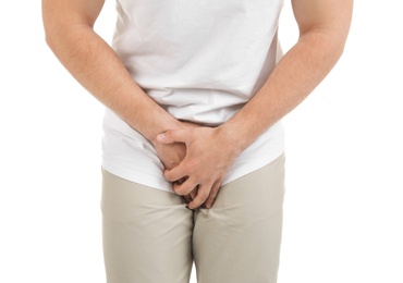 Photo of Young man with urological problems suffering from pain on white background