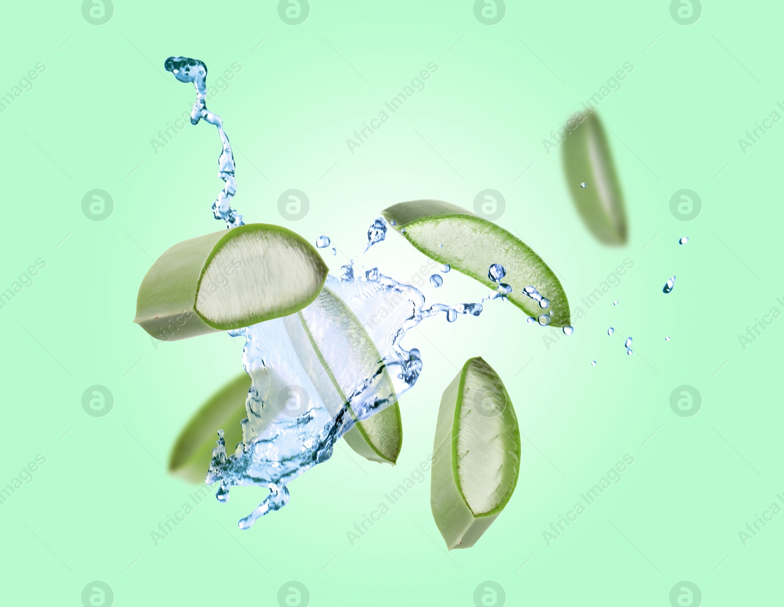 Image of Sliced aloe vera leaf and splashes of juice on aquamarine background