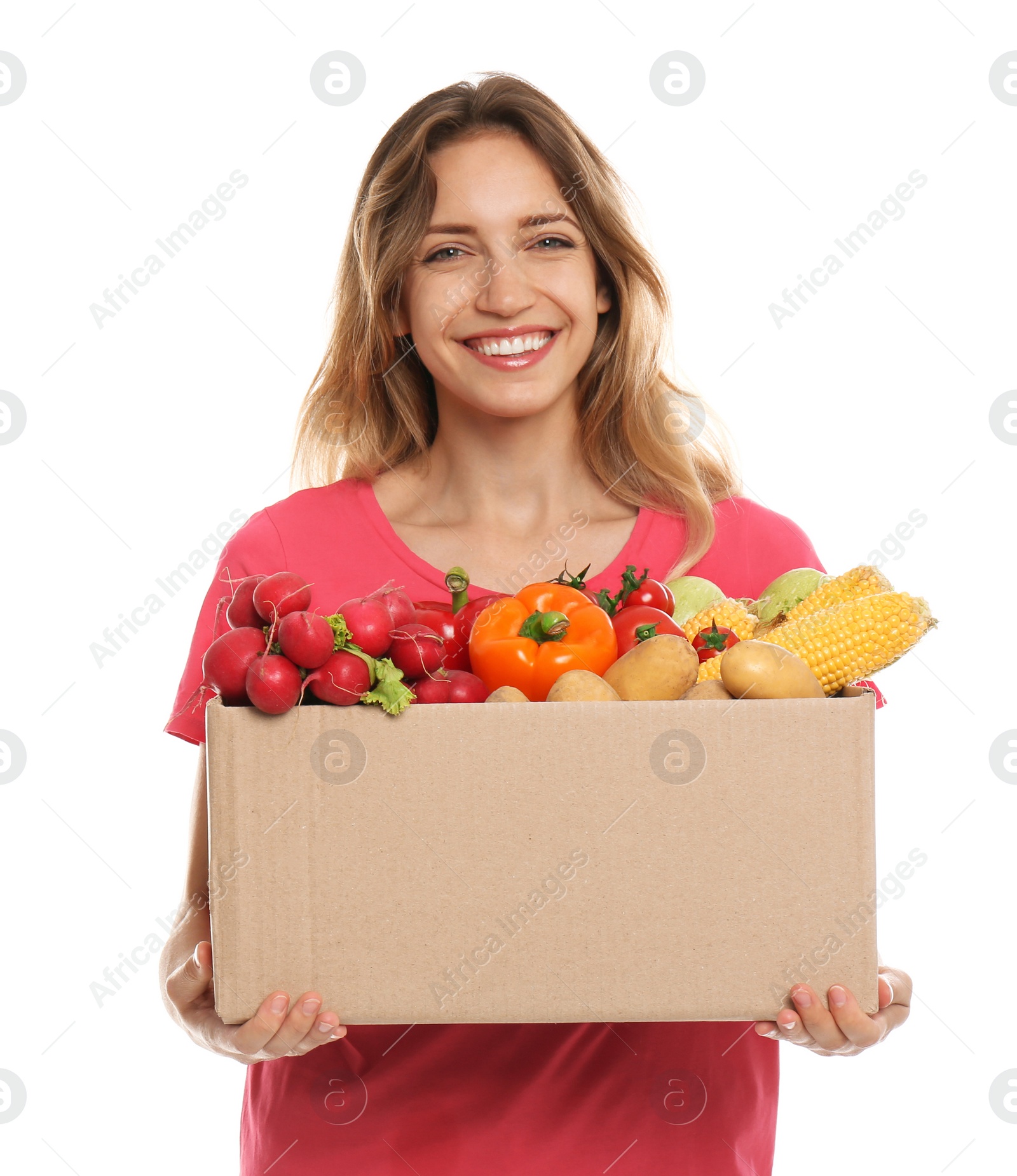 Photo of Young woman with box of fresh vegetables on white background