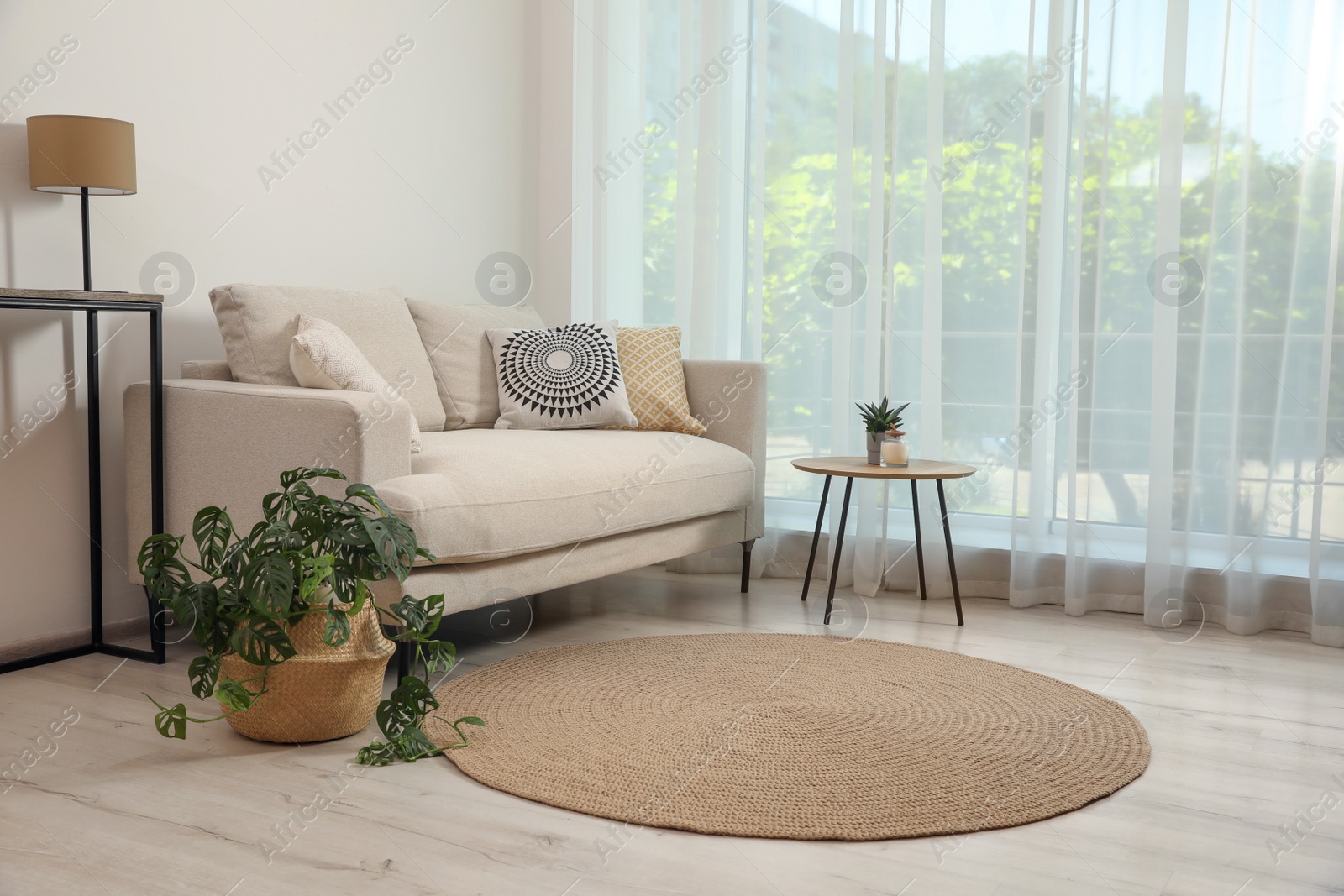 Photo of Living room interior with comfortable sofa and stylish round rug