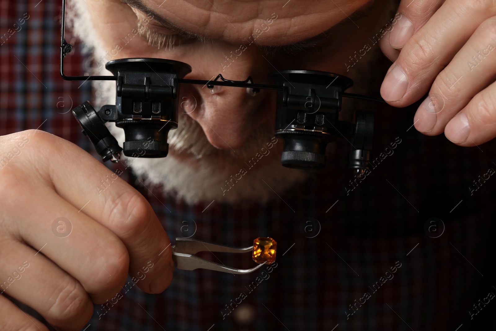 Photo of Professional jeweler working with gemstone, closeup view