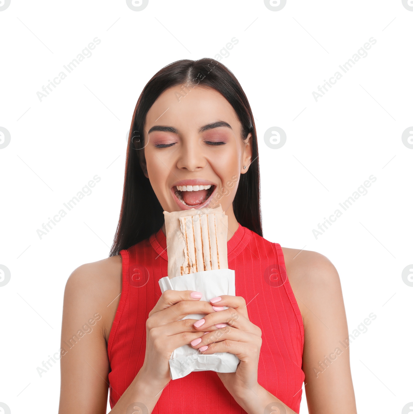 Photo of Young woman eating delicious shawarma on white background