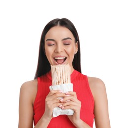 Young woman eating delicious shawarma on white background
