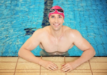 Photo of Young athletic man in swimming pool