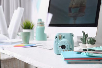 Photo of Digital camera on table in studio. Modern designer's workplace