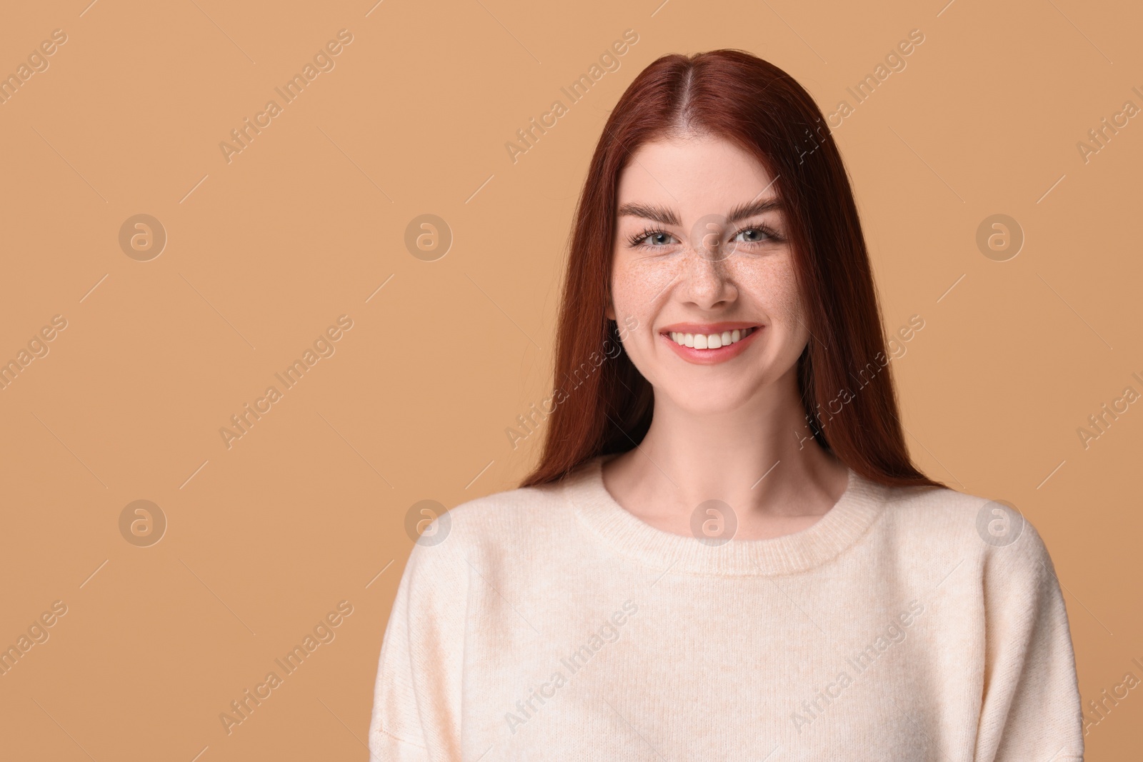 Photo of Portrait of smiling woman on beige background. Space for text