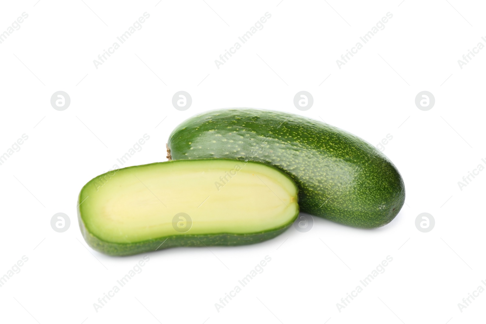 Photo of Cut and whole seedless avocados isolated on white