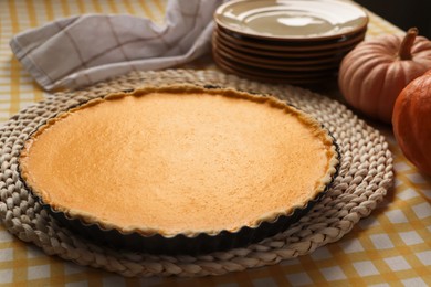 Photo of Delicious homemade pumpkin pie in baking dish on table