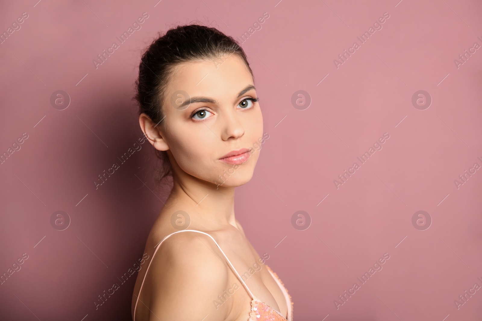 Photo of Young woman with beautiful makeup on color background. Professional cosmetic products