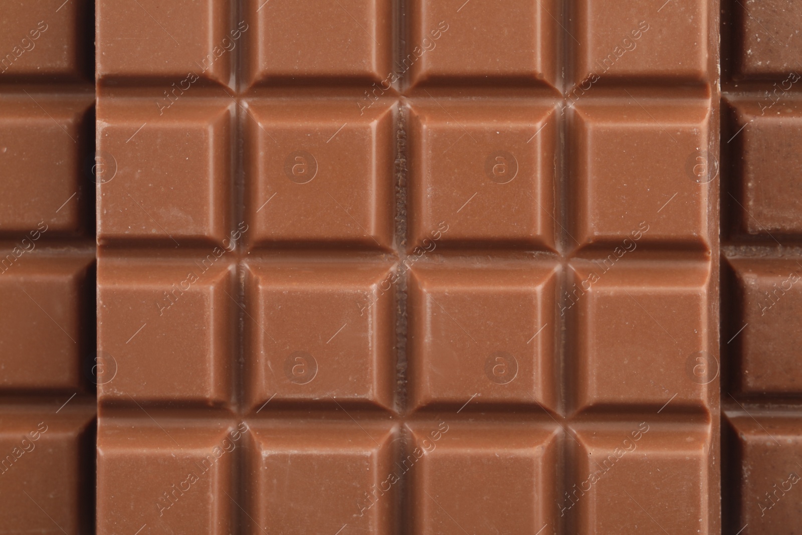 Photo of Delicious milk chocolate as background, closeup view