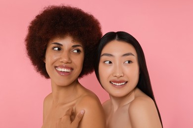 Portrait of beautiful young women on pink background