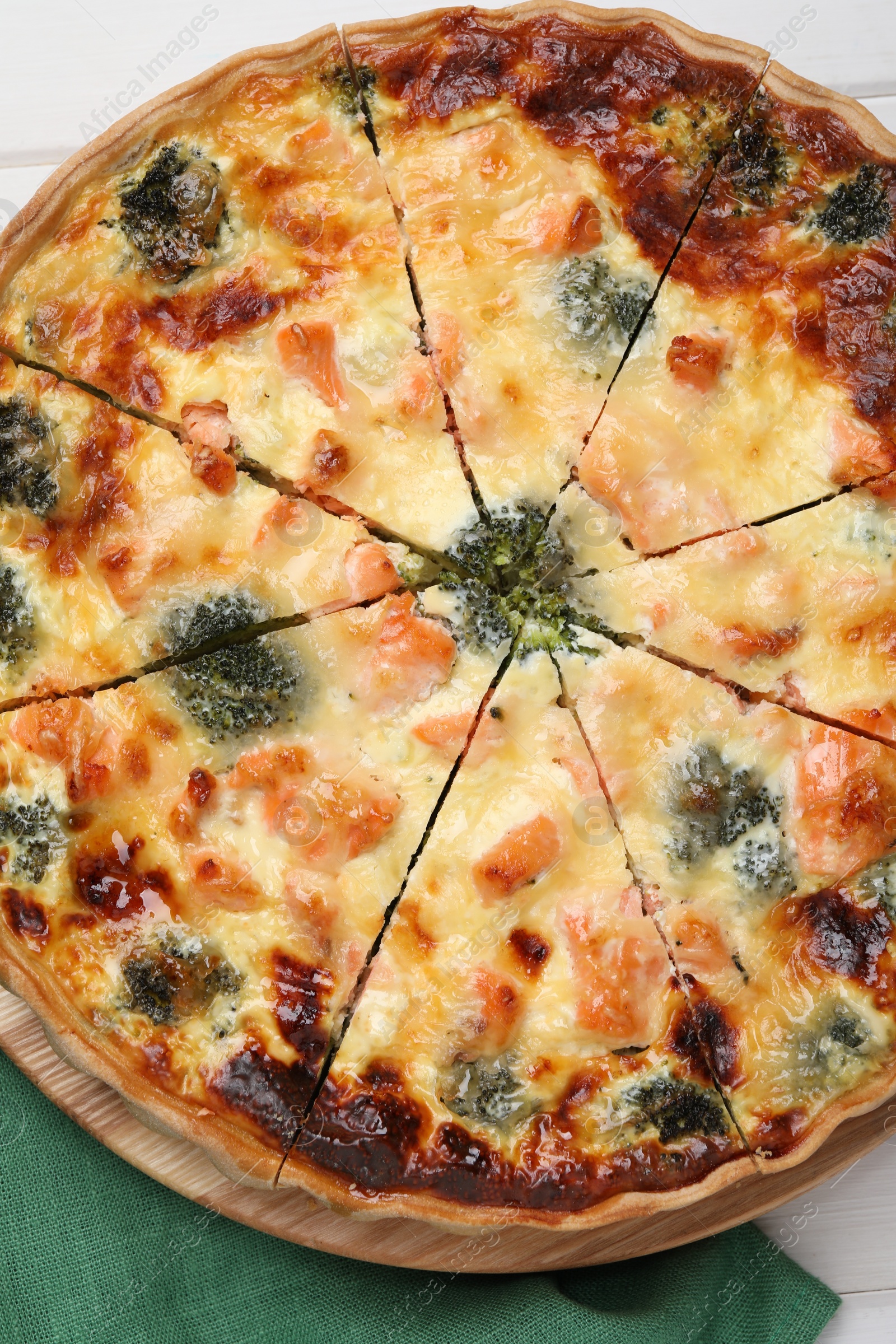 Photo of Delicious homemade quiche with salmon and broccoli on table, top view