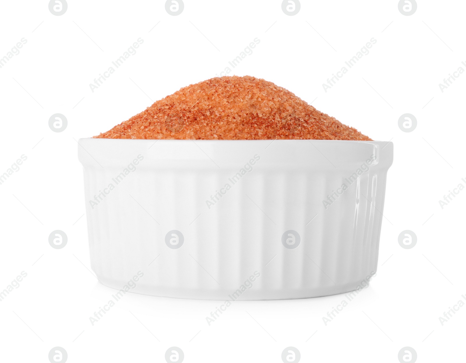 Photo of Orange salt in bowl isolated on white
