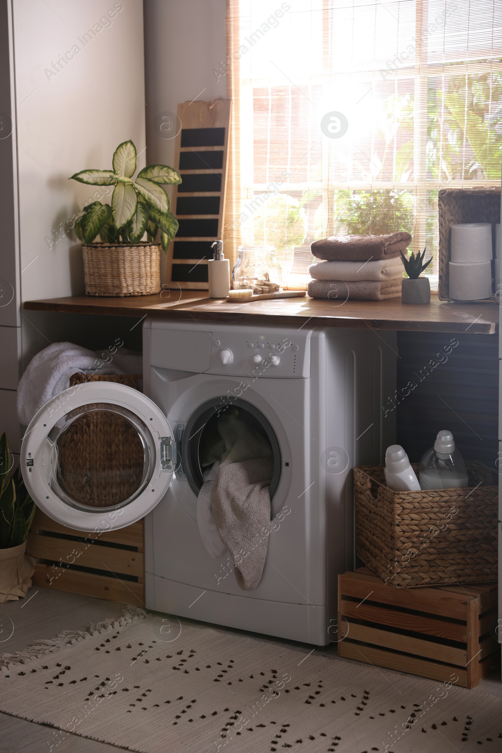 Photo of Stylish room interior with washing machine. Design idea