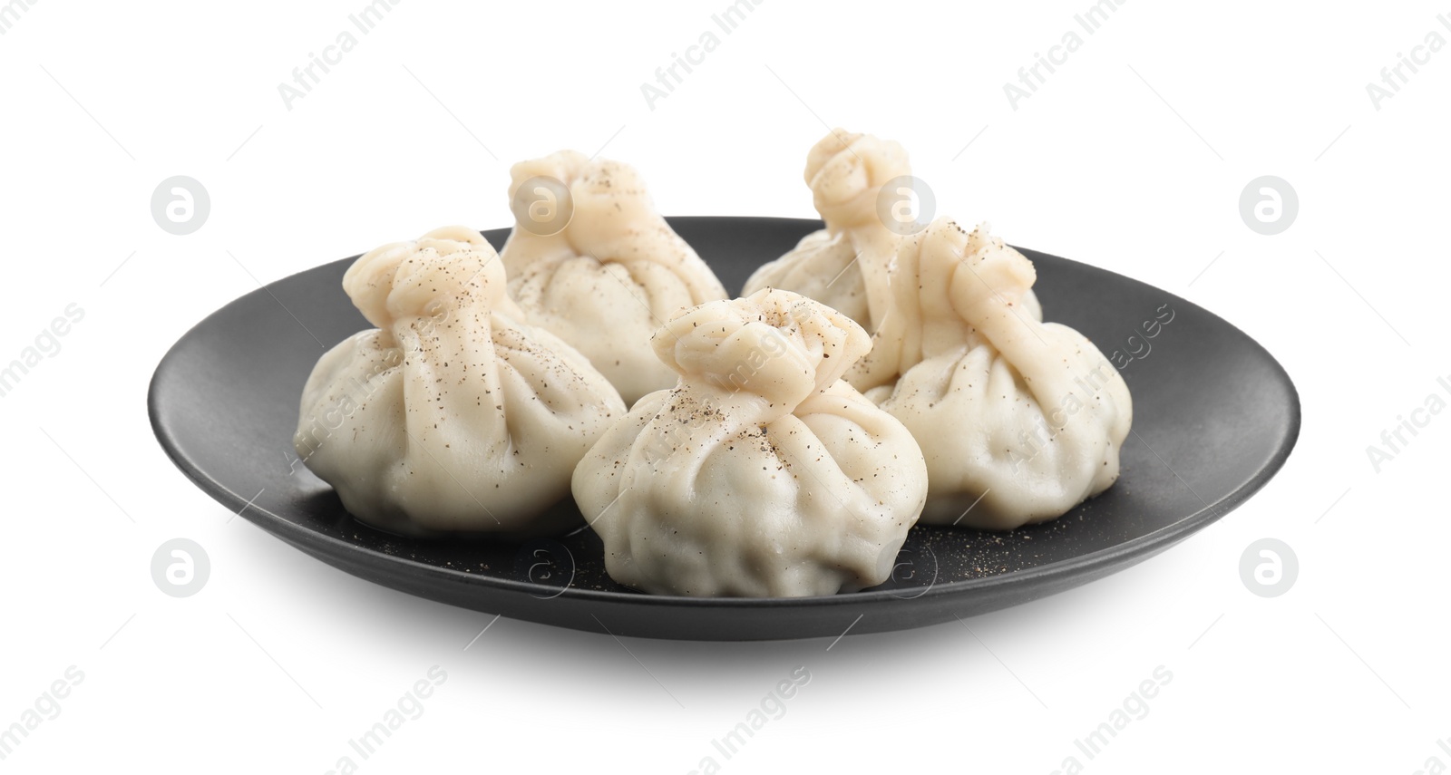 Photo of Plate with tasty fresh khinkali (dumplings) and spices isolated on white. Georgian cuisine