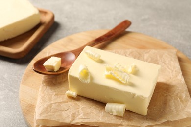 Photo of Block of tasty butter on grey table