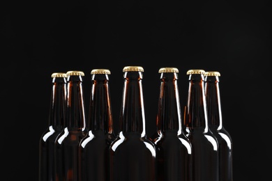 Photo of Many bottles of beer on dark background