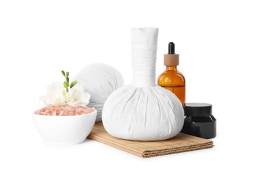 Herbal massage bags and different spa products on white background