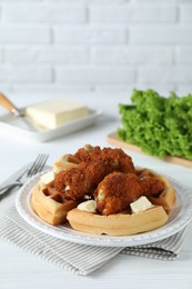 Delicious Belgium waffles served with fried chicken and butter on white table, space for text