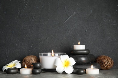 Photo of Spa composition with stones and candles on table