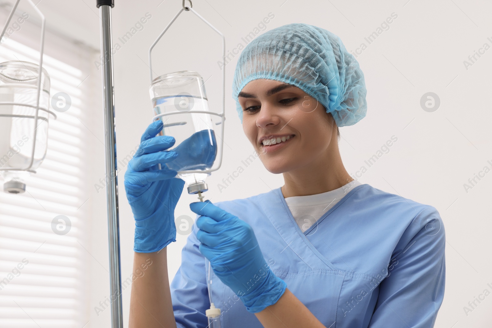 Photo of Nurse setting up IV drip in hospital