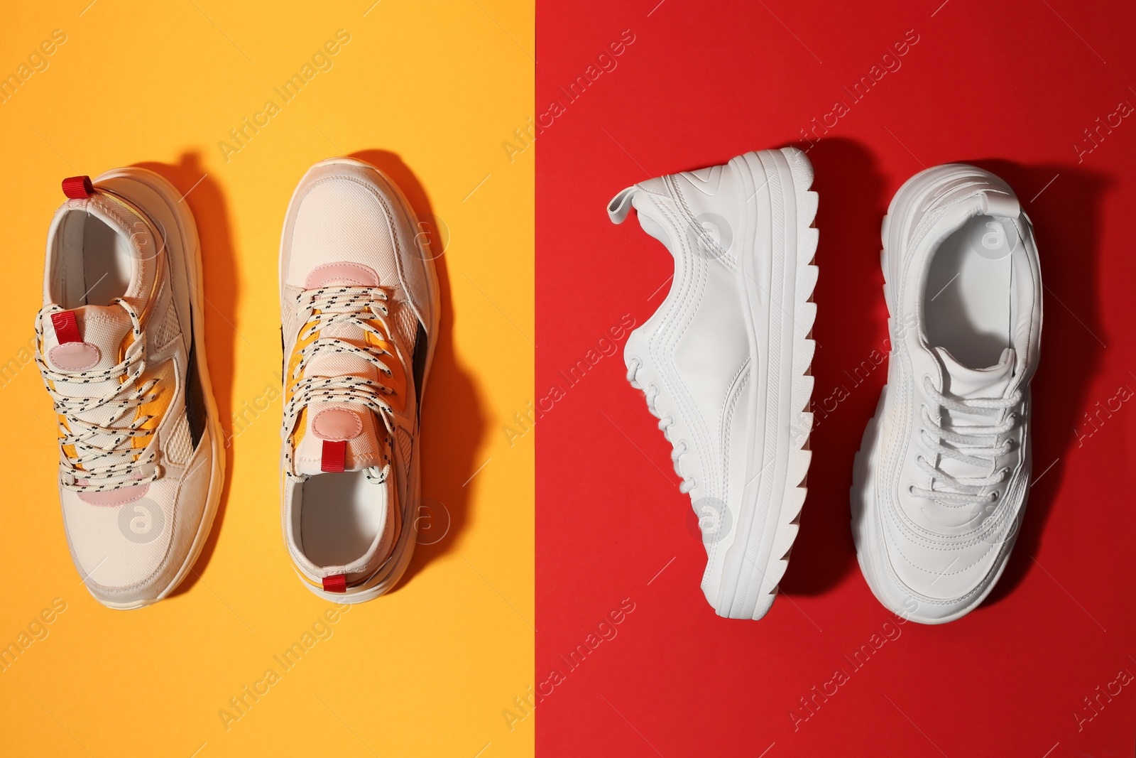 Photo of Pair of stylish sneakers on color background, top view