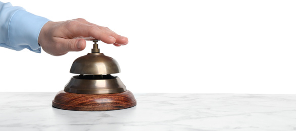 Photo of Man ringing hotel service bell at white marble table