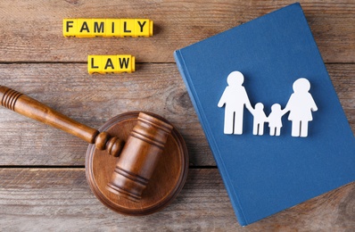 Image of Family law concept. Flat lay composition with book and judge gavel on wooden background