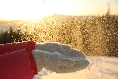 Young woman having fun outdoors on snowy winter day, closeup