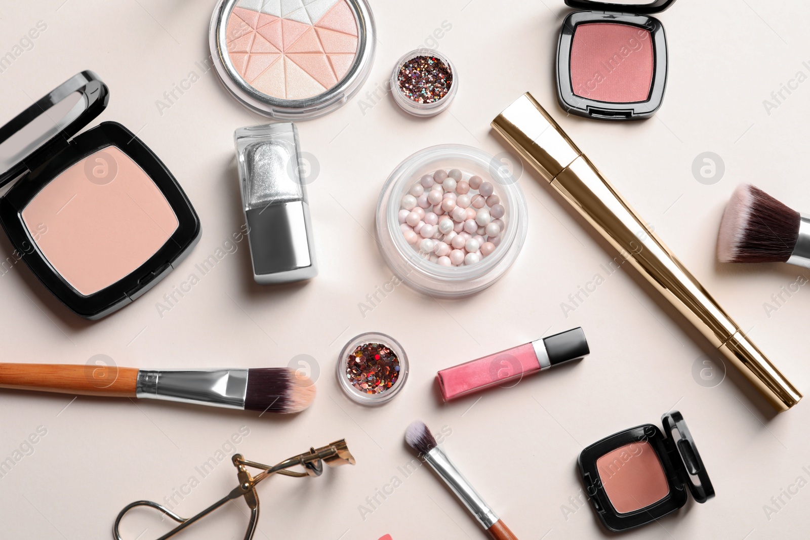 Photo of Decorative cosmetics and tools of professional makeup artist on color background