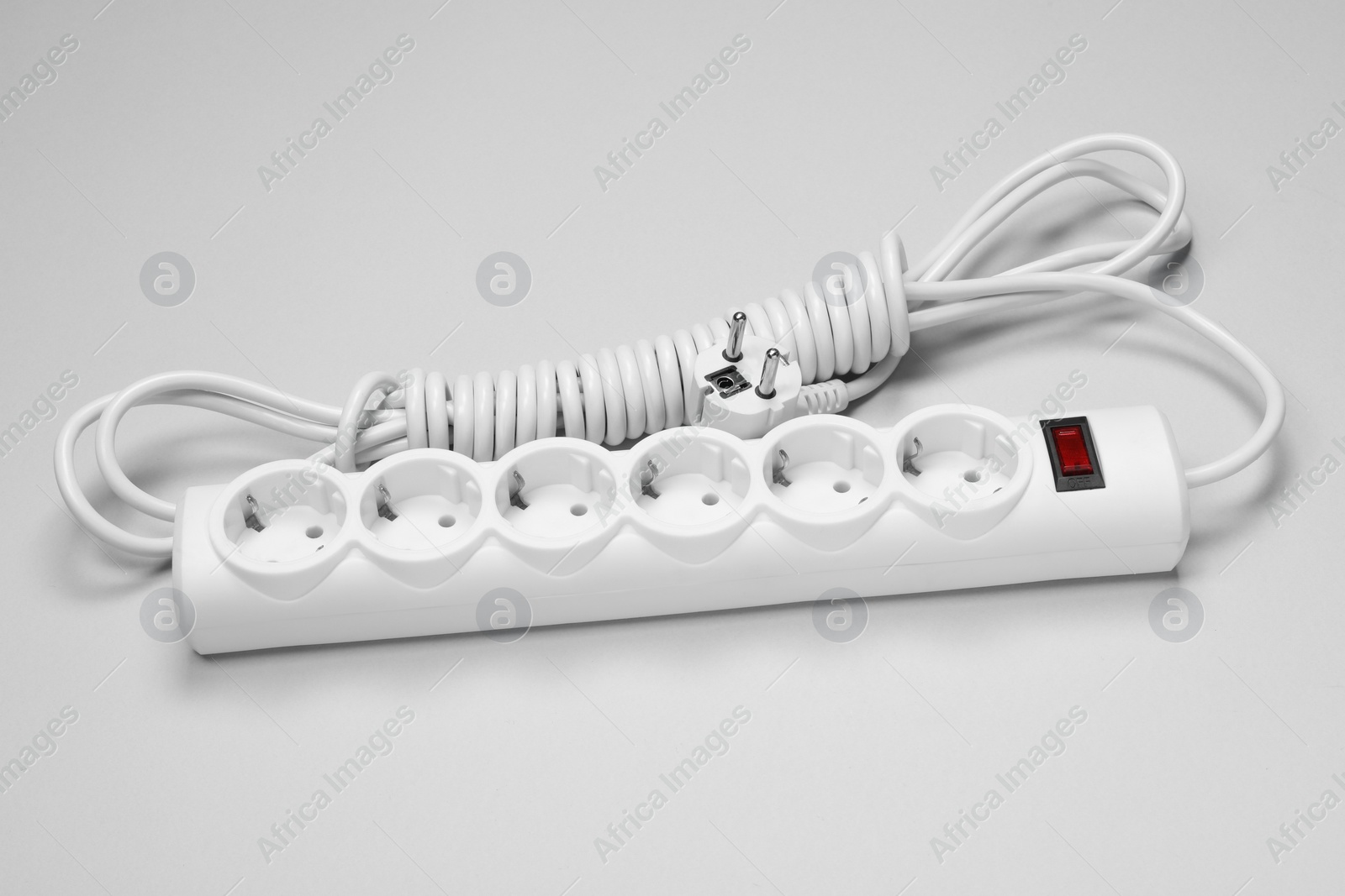 Photo of New power strip on white background. Electrician's equipment