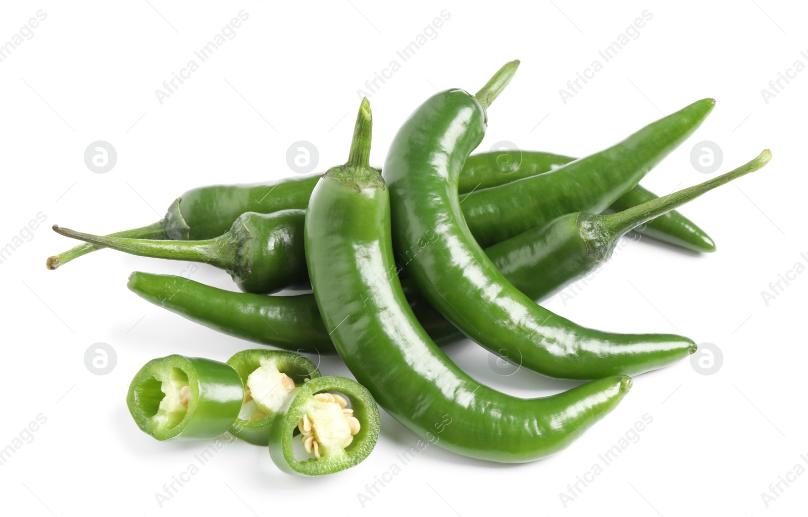 Photo of Cut and whole green hot chili peppers on white background