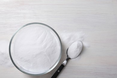 Photo of Baking soda on white wooden table, top view. Space for text