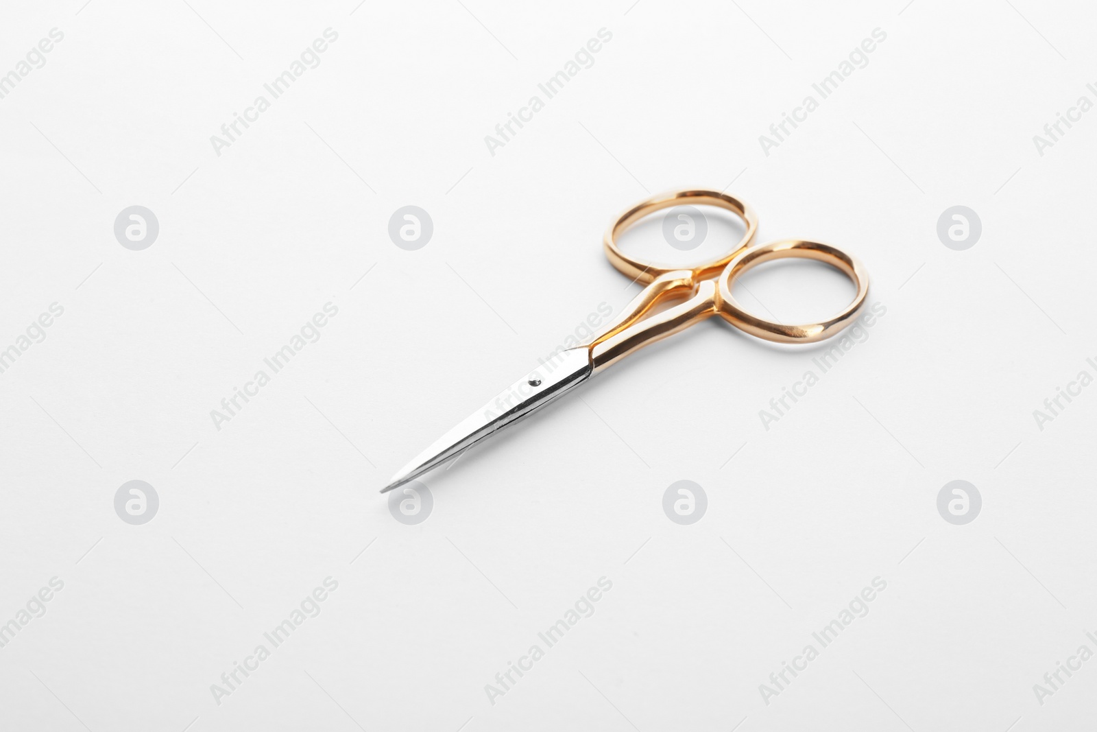 Photo of Pair of sharp sewing scissors on white background