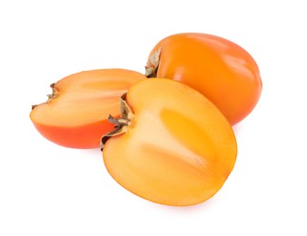 Photo of Whole and cut persimmon fruits isolated on white