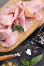 Photo of Tasty ham with basil and spices served on grey table, flat lay