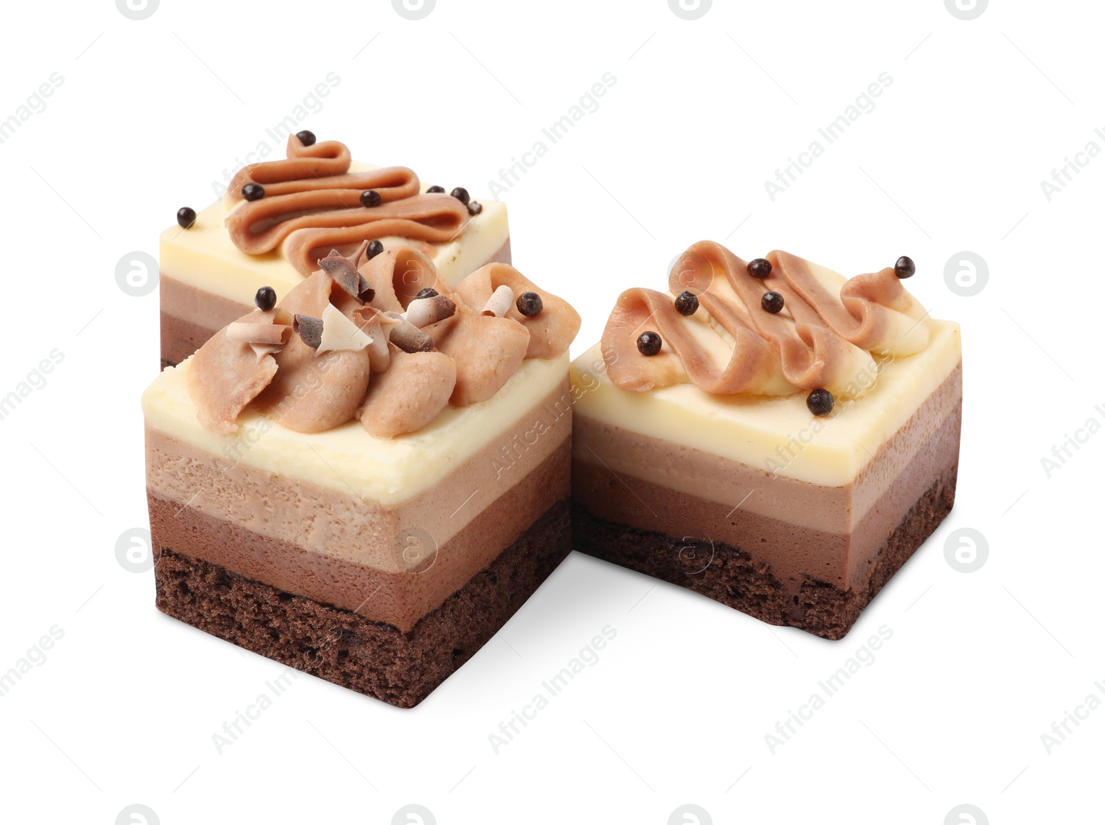 Photo of Pieces of triple chocolate mousse cake on white background