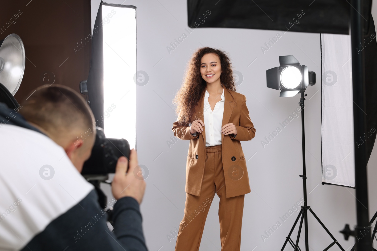 Photo of Beautiful African American model posing for professional photographer in studio