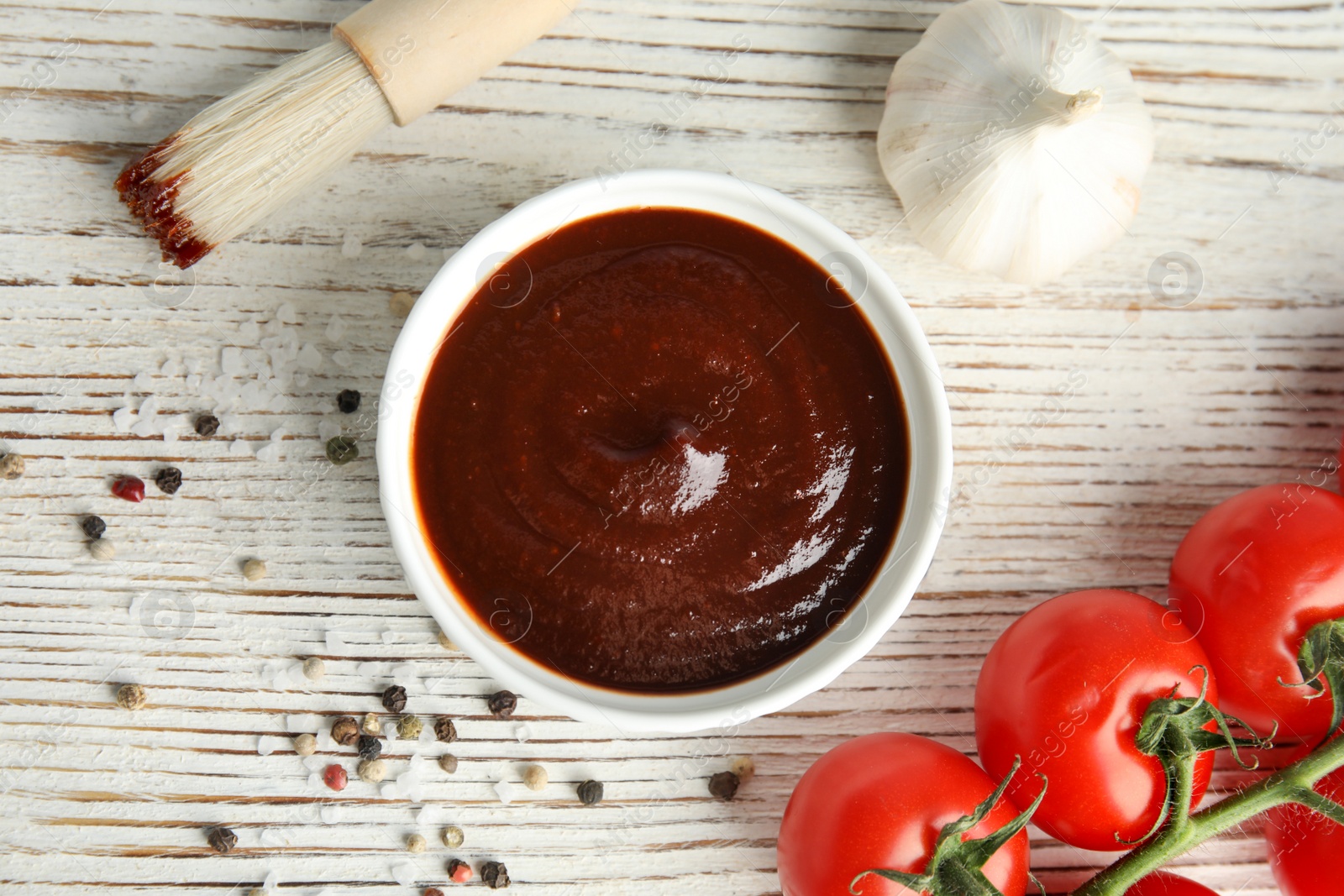 Photo of Flat lay composition with barbecue sauce on white wooden table