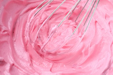 Photo of Whipping pink cream with balloon whisk, closeup view