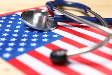 Stethoscope and USA flag on table, closeup. Health care concept