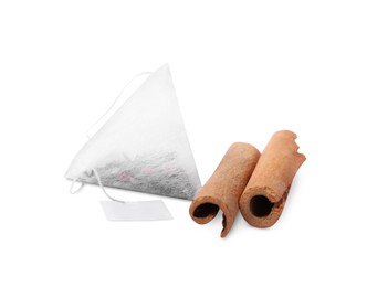Photo of Tea bag and cinnamon sticks on white background