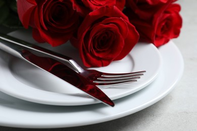 Romantic table setting with rose flowers, closeup