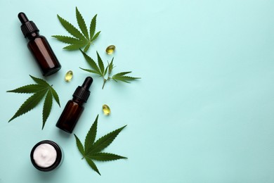 Photo of Flat lay composition with hemp leaves, CBD oil and THC tincture on light blue background, space for text