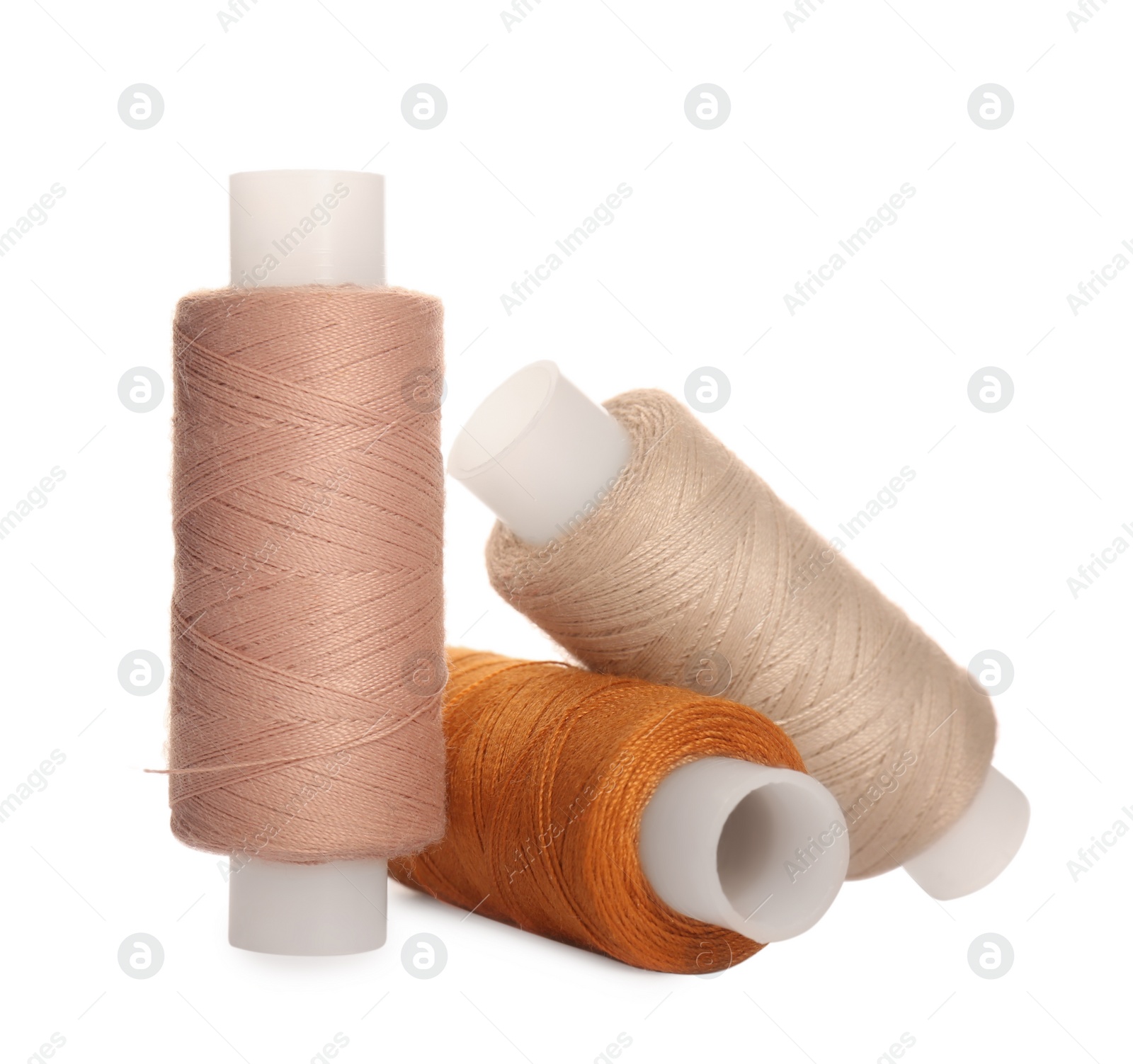 Photo of Different colorful sewing threads on white background